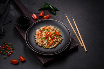 Delicious fresh noodles with sweet pepper, tomato, spices and herbs