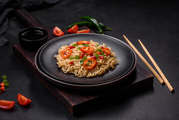 Delicious fresh noodles with sweet pepper, tomato, spices and herbs