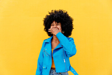 Beautiful young black woman outdoors in the city - Afro american cheerful female adult portrait