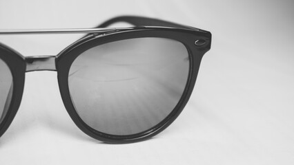 Dark sunglasses isolated on white background. Black and white photo.