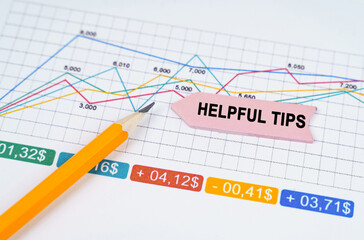 On business charts there is a pencil and an arrow sticker with the inscription - Helpful Tips