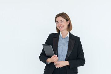 Young attractive and smiling business woman in black suit holding gadget isolated on white. Copy space and place for text concept