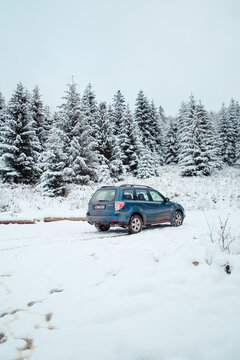 Blue Subaru Forester SH generation III 2011, with FB20 engine on a snowy forest road. Winter landscape. F9H paint color.