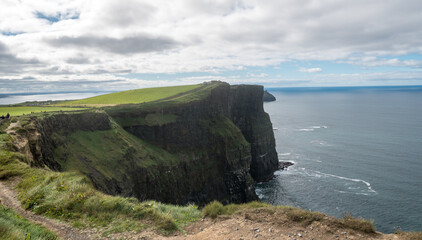 Fototapeta na wymiar Spectacular view of famous Cliffs of Moher and wild Atlantic Ocean, cloudy day, County Clare, Ireland.