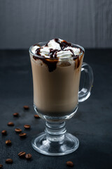 Frappuccino coffee with cream and chocolate syrup in a mug.