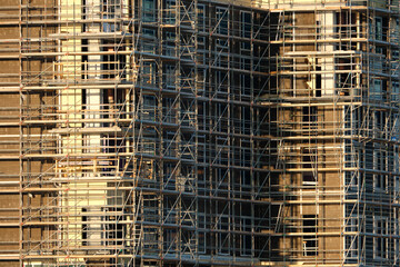 Tower lifting cranes at high residential apartment buildings construction site. Real estate development