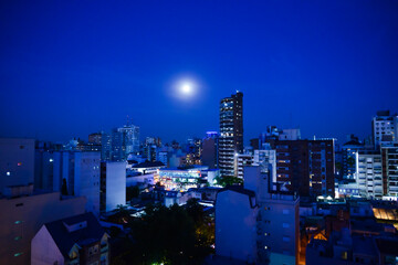 Full moon in the city at the blue hour