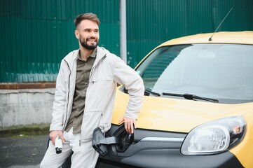 Man charging his electric car.