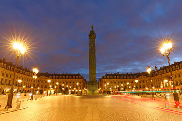 Fototapeta premium Vendome column with statue of Napoleon Bonaparte, on the Place Vendome decorated for Christmas at rainy night , Paris, France.