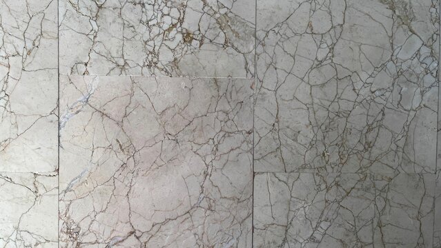 Wall texture. Ivory material. Marble texture. Cracks in the wall. Gray background