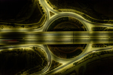 Aerial drone top view of motorway junction. Roundabout  cars moving. Transportation infrastructure