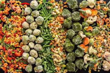 Frozen vegetable mix, frozen green beans and broccoli, corn and carrots, brussels sprouts and cauliflower, peas and bell peppers, eggplant and zucchini, top view