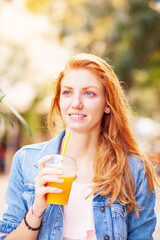 woman drinking juice outdoors
