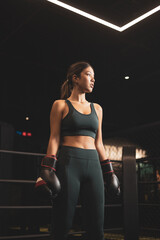 Female boxing,Asian girl rest standing in the ring,Youth sports concept.
