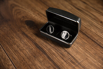 Black cufflinks on the table