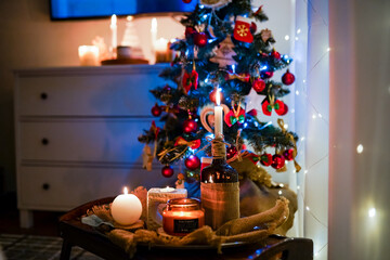 New Year 2022-2023. New Year's decoration. Christmas tree. Candle near the Christmas tree for the holiday.