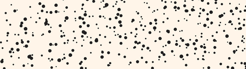 Spots pattern on nude background. Horizontal panoramic banner template. Irregular dots pattern. Creative small splash blots pattern. Abstract black stains on beige backdrop.