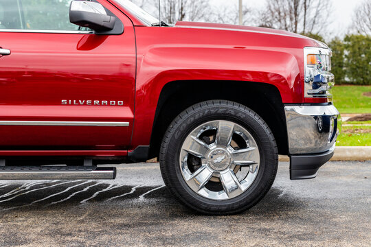 JOLIET, IL, USA - APRIL 7, 2019: A side picture of a red and rain covered 2017 Chevrolet Silverado 1500 LTZ 4WD.
