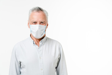 Mature middle-aged businessman freelancer grandfather wearing protective face mask against coronavirus isolated in white background. Pandemic concept. Social distance