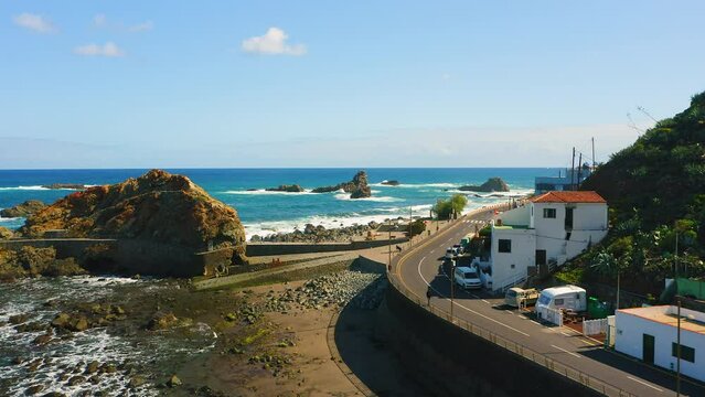 Rocky ocean coast with mountain touristic spot settlement small village in the north of Tenerife Island. Almaciga main street with beach Roque de las Bodegas. Canaries Spain.