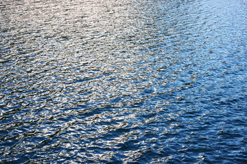 Blue water background. Ripple sea ocean water surface. still calm sea ocean water surface. close up blue water surface at deep ocean. Light blue background