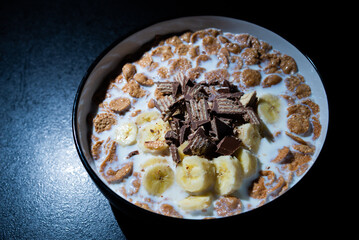 Cereal dessert with milk and banana with chocolate