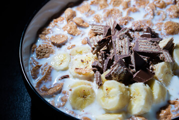 Cereal dessert with milk and banana with chocolate