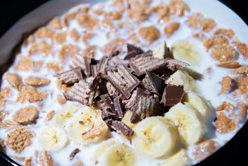 Cereal dessert with milk and banana with chocolate