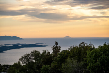 Mystical sunset above Adriatic sea and islands of Hvar and Komiza, photographed from Vidova Gora, highest peak on Brac island, Croatia - obrazy, fototapety, plakaty