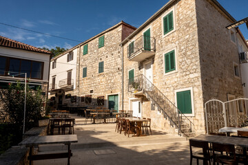 Fototapeta na wymiar Lovely stone square and narrow, stone streets of Supetar, famous tourist destination on Brac island, Croatia