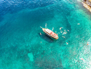 Aerial photo of tourist sailing boat anchored in magnificent, turquoise bay of Brac island, with...
