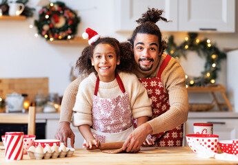 Positive black father and daughter cooking together on christmas holiday