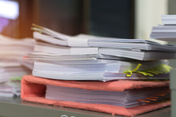 Overload stack binder documents of report papers for research teacher classroom planning on desk waiting to managed or approve, unorganized management stock files for check. Workload in work concept