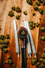 Wooden pipe for smoking on the table against the background of a bud of cbd sativa or indica tgk. Joints