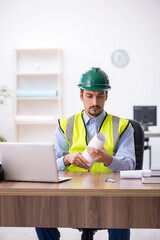 Young male architect working in the office
