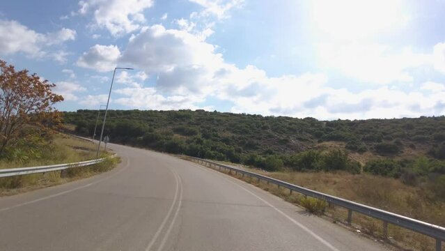 Time lapse of Driving on an empty road in Greece in the mountains on a sunny day