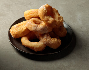 A dish with donuts. Hot street sweet food. Fast food