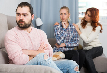 Adult guy having argue with wife and mother-in-law. High quality photo