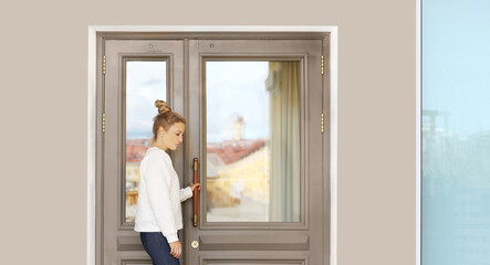 Beautiful woman opening the door of her home.