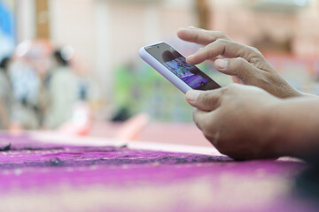 Businesswoman using Finger touching gadget choose app on smartphone mobile phone in conference room. Browsing apps icon while open e-learning online tablet at meeting room