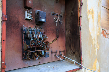 Fototapeta na wymiar Old metal rusty electrical panel. Background with selective focus