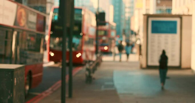 City morning, line of red buses in street busy with traffic on a summer day in London. Travel, tourism in England and public transport with double decker bus driving on schedule, commute in cityscape