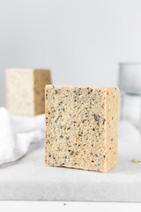 Black sesame seed bread on a white chopping board, poppy seed bread, pullmans loaf, sandwich loaf