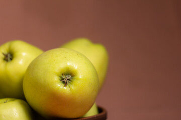 Close-up of fresh juicy golden apples with blurred background