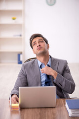 Young male employee working in the office