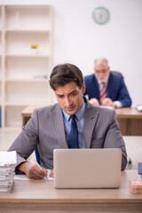 Two male colleagues sitting in the office