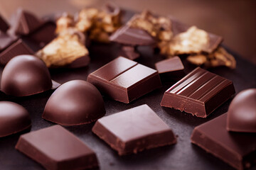 pieces of chocolate lie on a wooden table