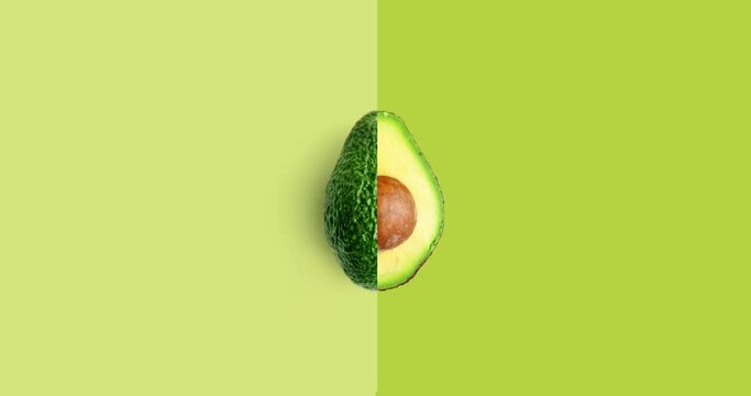 Creative animation made of avocado full an peeled on the green background. Animation concept food. 