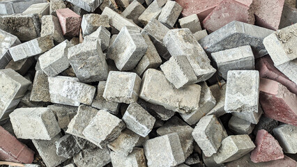 Broken block paving stone. Stacked in one place. Can be used as a background. Photographed in landscape mode.