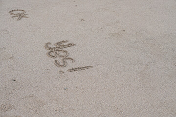 hand written on sand